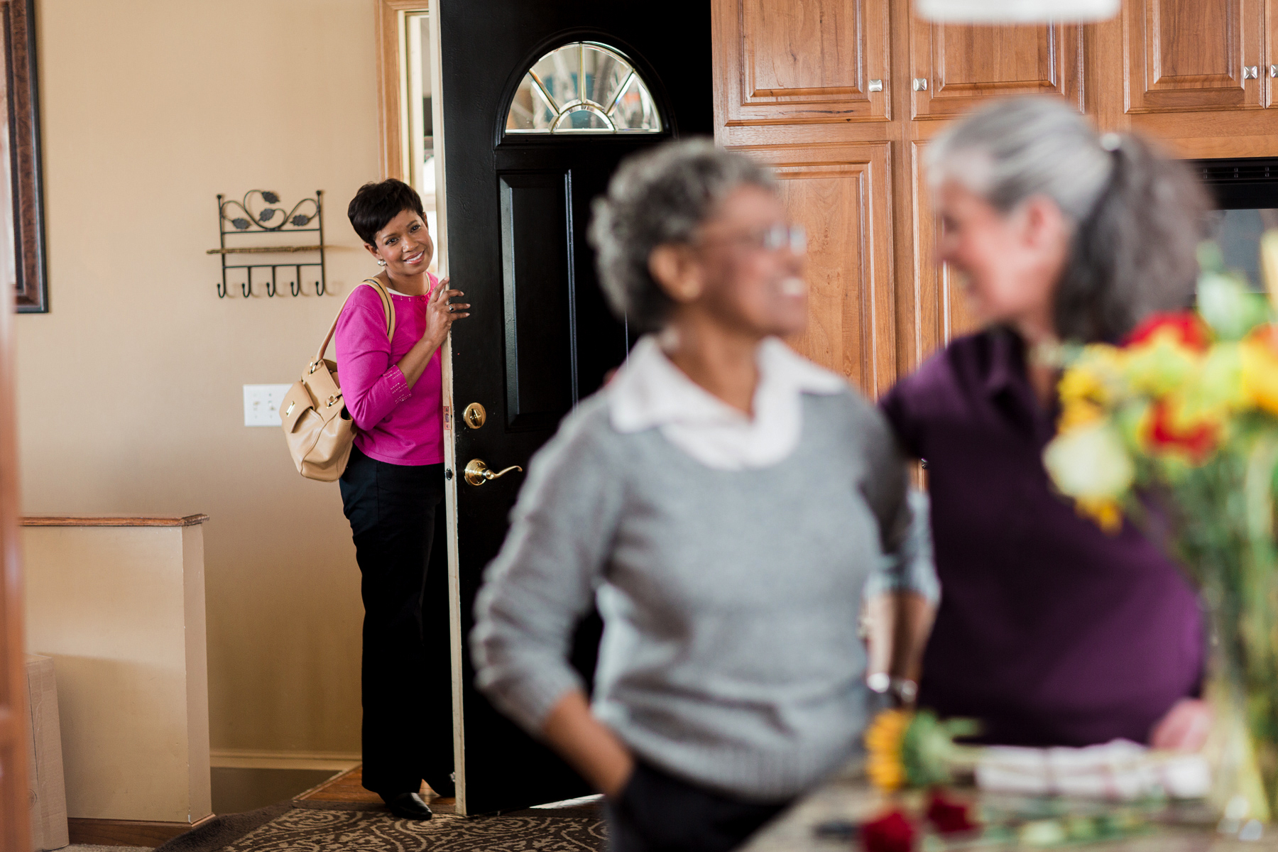 Kathy at front door seeing CAREGiver and senior putting flowers in vase 28